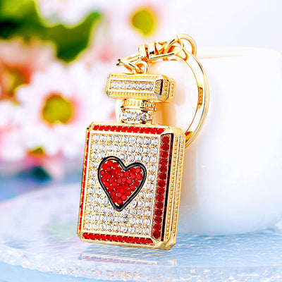 Main image 1 shows a supplied presentation of jeweled heart perfume bottle keychains with visible attached key hardware.