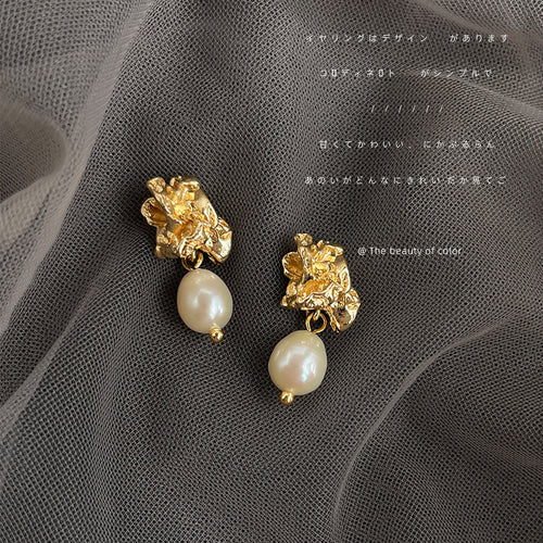 Gold crumpled studs with pearl drops on gray mesh fabric