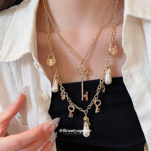 Gold Tone Layered Charm Necklaces With Decorative Accents