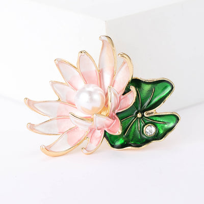 Pink Lotus brooch styles arranged on a light display