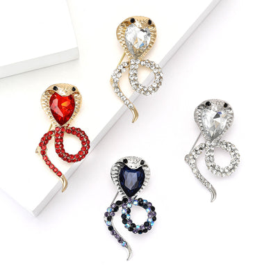 Coiled Crystal Cobra Snake Brooch With Teardrop Head shown from the front on a white background