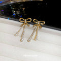 Gold Tone Bow Stud Earrings With Pearl Chain Tassels view 3