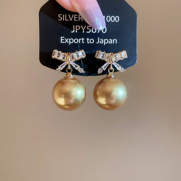 Champagne Pearl and Crystal Bow Stud Earrings with Gold Tone Details