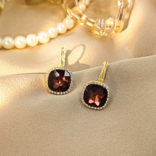 Gold burgundy square gem crystal halo leverback earrings on beige fabric