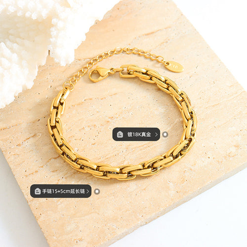 Gold curb bracelet on stone with coral and length plating labels