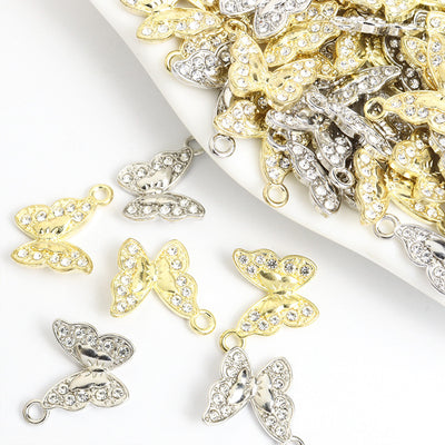 Assorted butterfly charms arranged on a white surface