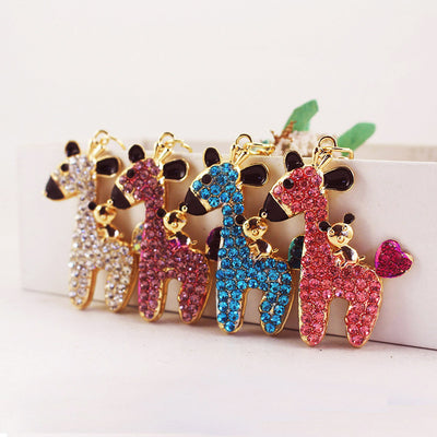 Four jeweled deer charms displayed in white, purple, blue, and pink colors.