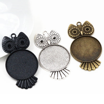 Large Owl Round Cabochon Pendant Bases in Bronze and Silver shown in a grouped front view