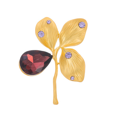 Front product view of an 18k gold and garnete brooch