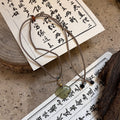 Green Cloud Pendant Necklace on Layered Brown Cords view 2
