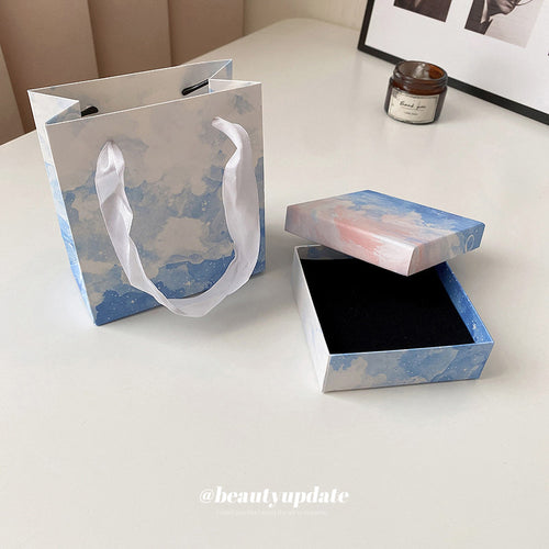 Front view of blue cloud jewelry packaging