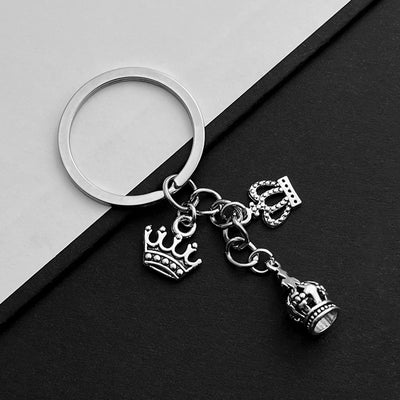 Front product photo of antique silver openwork crown charm keychain with round ring showing the pictured design arrangem