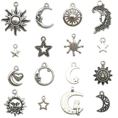 Silver-tone sun and moon charms arranged on a light background