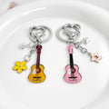 Guitar Shaped Charm Keychain With Star And Flower Pendants view 3