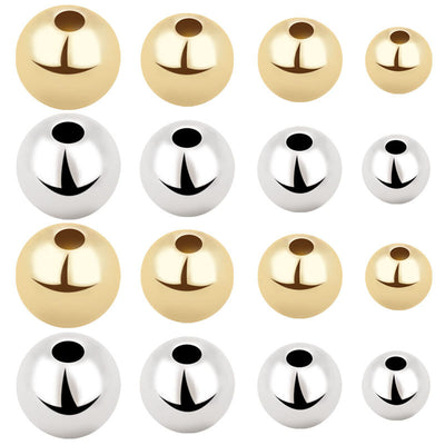 Gold-tone round bead beads arranged on a light background