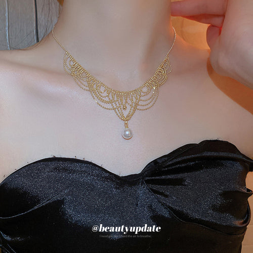 Gold lace mesh pearl drop choker worn with black satin top