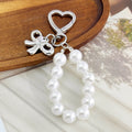 Pearl Beaded Bag Charm With Heart Shaped Clasp And Bow view 4