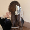 White Satin Bow Hair Claw With Black Piping And Pearl Like Center view 3