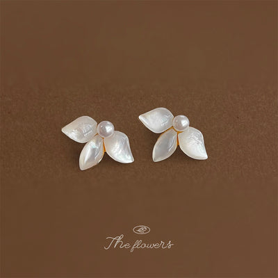 Gold-tone pearl-center white-shell-leaf studs in the first product display.
