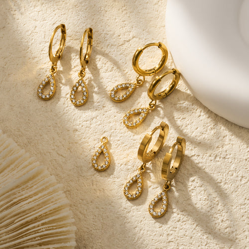 Display view of gold tone crystal teardrop hoop earrings in main image 2.