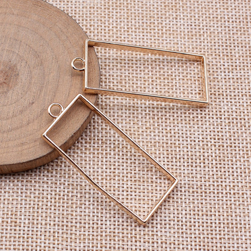 Tall Rectangle Open Frame Pendants in Four Metal Finishes shown in image 2, highlighting a slim open rectangle, flat wir