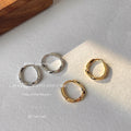 Faceted Texture Huggie Hoop Earrings In Silver And Gold Tone view 1