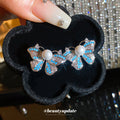 Blue Butterfly Stud Earrings with Pearl Like Centers and Crystals view 2
