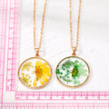 Gold Tone Round Resin Pressed Daisy Pendant Necklaces in Six Colors view 5