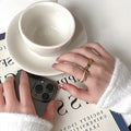 Three Gold Tone Ring Designs With White Inlay And Block Details view 4