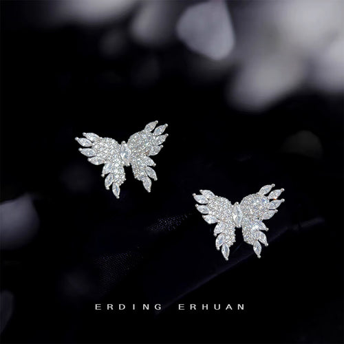 Silver pave crystal butterfly stud earrings on black fabric