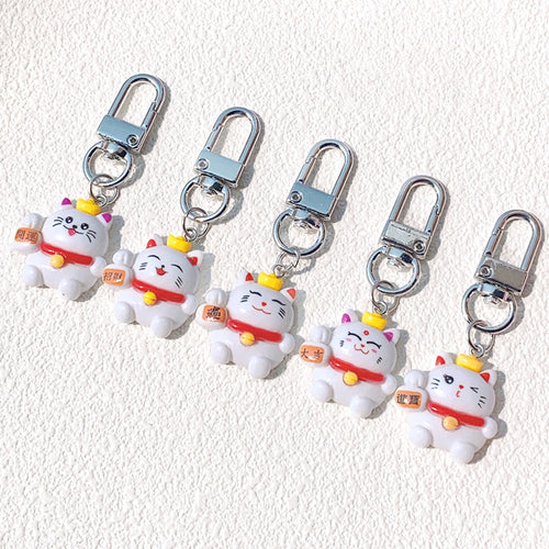 Close-up showing the colors and surface details of white Fortune Cat Resin Clip Keychains in Five Designs