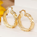 Gold Tone Wavy Concave Twisted Side Hoop Latch Earrings view 3