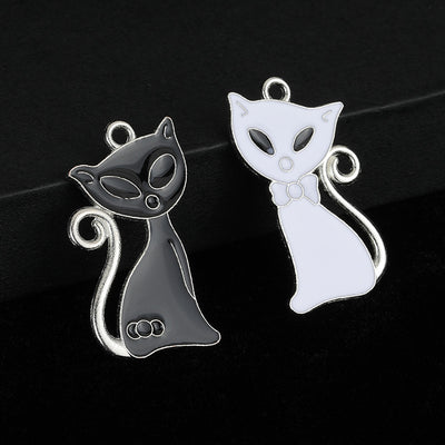 Black and white enamel cat charms shown side by side with silver-tone jump rings