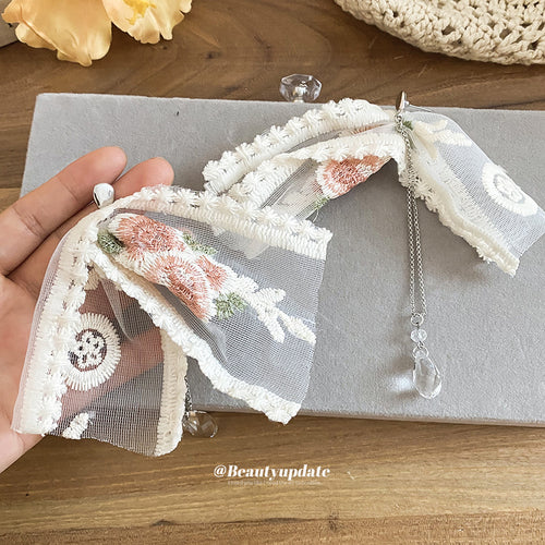 Long floral fabric bows edged in lace with clear bead drops in a close product view.