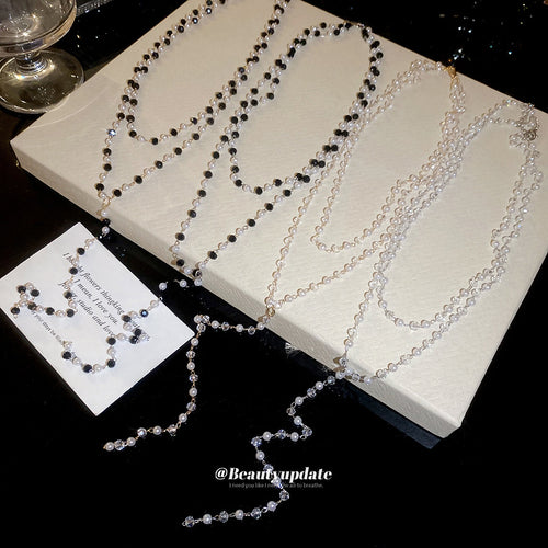 Arranged product view of the layered beaded  with long curved drop in four colorways necklace shown in image 2