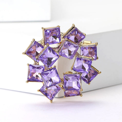 Purple square crystal ring brooch angled on white display blocks