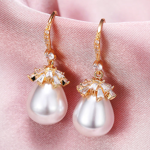 pearl drop earrings with crystal flower caps shown from a side angle