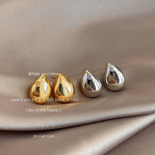 Gold and silver polished teardrop dome studs on satin