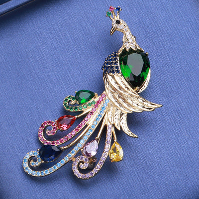 Front view of peacock with a green faceted body and multicolor curled tail feathers