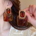 Gold Square Resin Drop Earrings in Amber and Ivory Tones view 3