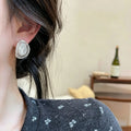 Silver Tone Oval Mesh Stud Earrings with Textured Centers view 3