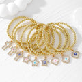 Gold Tone Beaded Crystal Evil Eye Flower Star and Cross Bracelets view 1