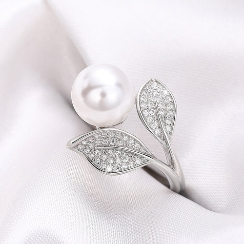 White metal pearl twin leaf pavé bypass ring on white silk