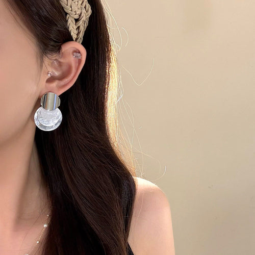 White Translucent Disc Drop Earrings with Brushed Studs shown in a display view