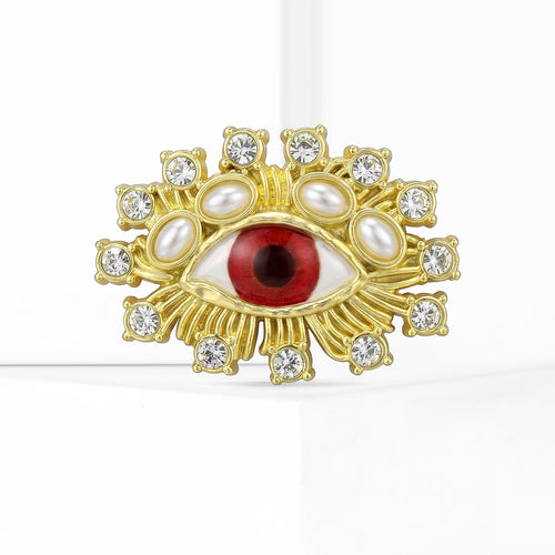 Red Eye brooch With Pearls And Clear Crystal Frame shown in styled product arrangement