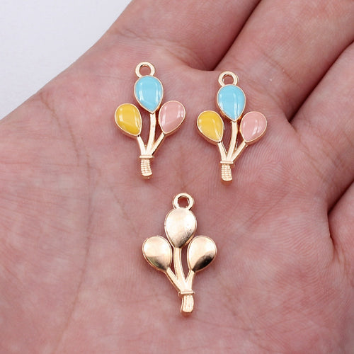 Enamel balloon bouquet charms shown on a hand for scale