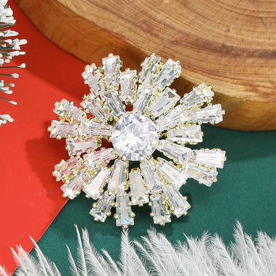 Front view of radiant crystal snowflake brooch in gold and silver tone