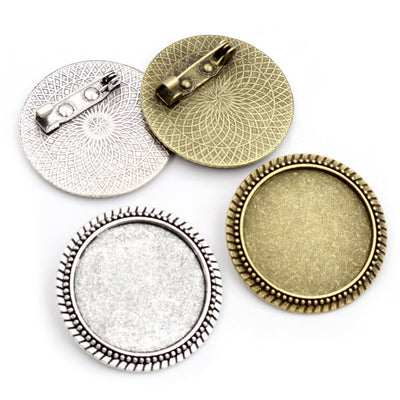 Round Cabochon Brooch Bezel Settings in Two Finishes, grouped overview on a plain background