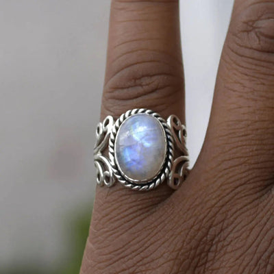 Product view showing antiqued silver-tone opalescent oval filigree ring