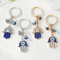 Blue Evil Eye Hamsa Hand Metal Keychains in Four Designs view 1